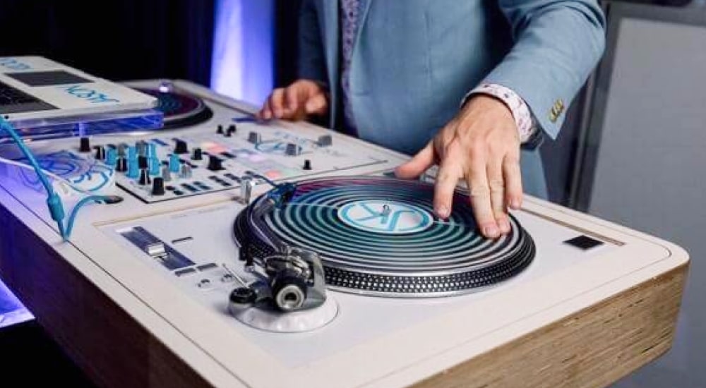 DJ table with a hand preparing to spin a record