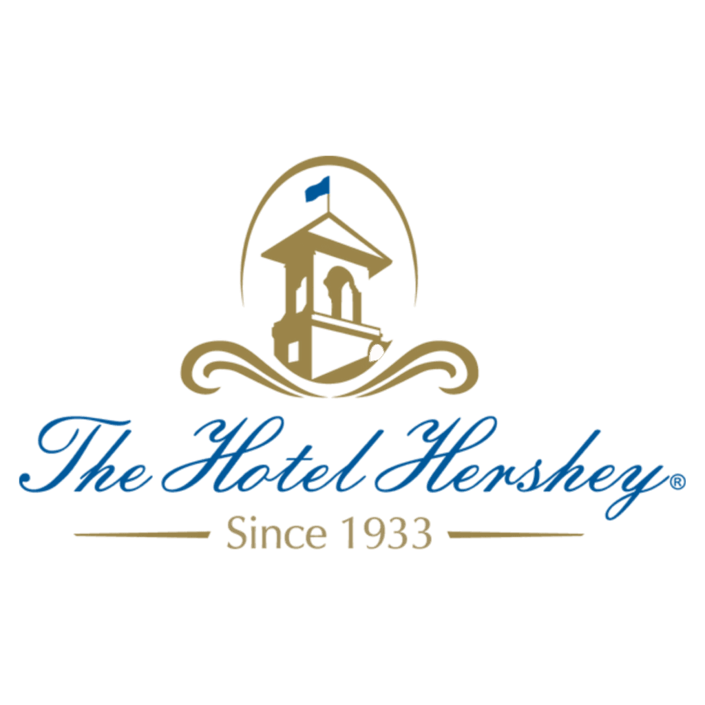 Logo of The Hotel Hershey featuring a stylized building with a blue flag, the hotel name in script font, and the phrase "Since 1933" beneath in gold text.