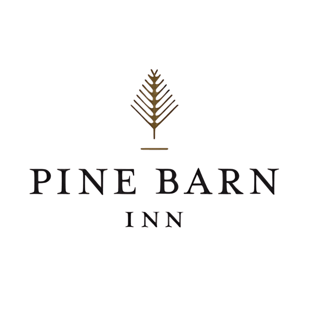 Logo for Pine Barn Inn featuring a simple pine branch graphic above the text "Pine Barn Inn" in black capital letters on a white background.