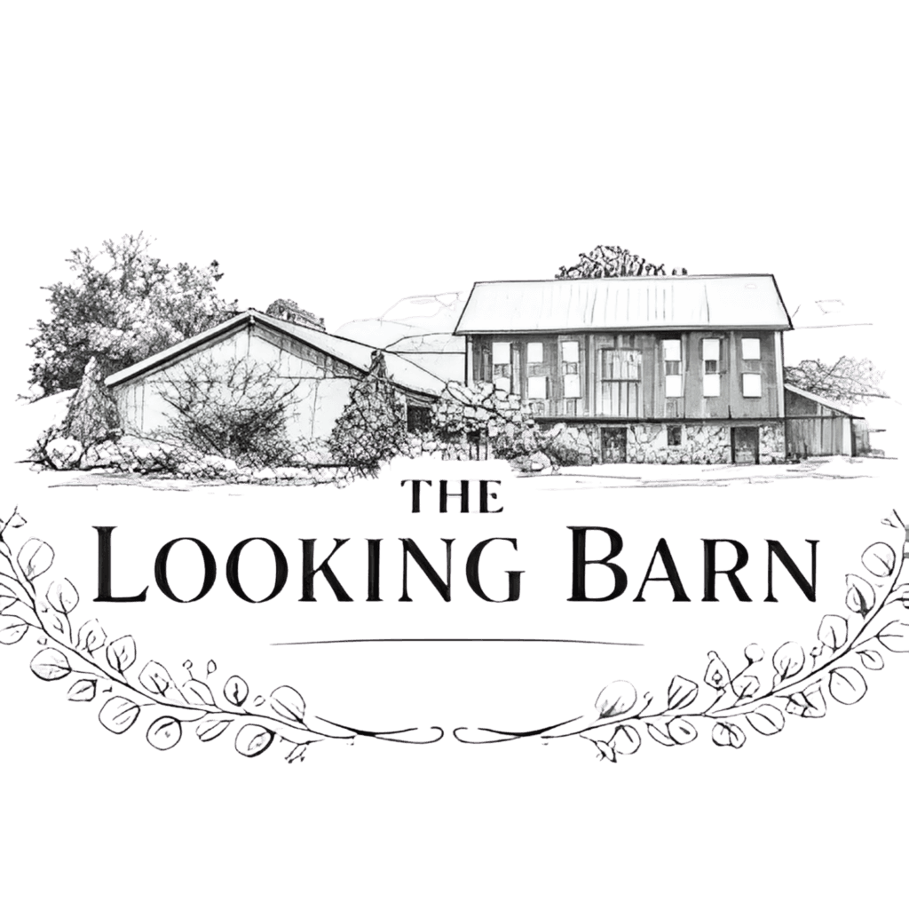 A black and white sketch of a barn with trees, featuring the text "The Looking Barn" below, framed by a decorative leafy border.