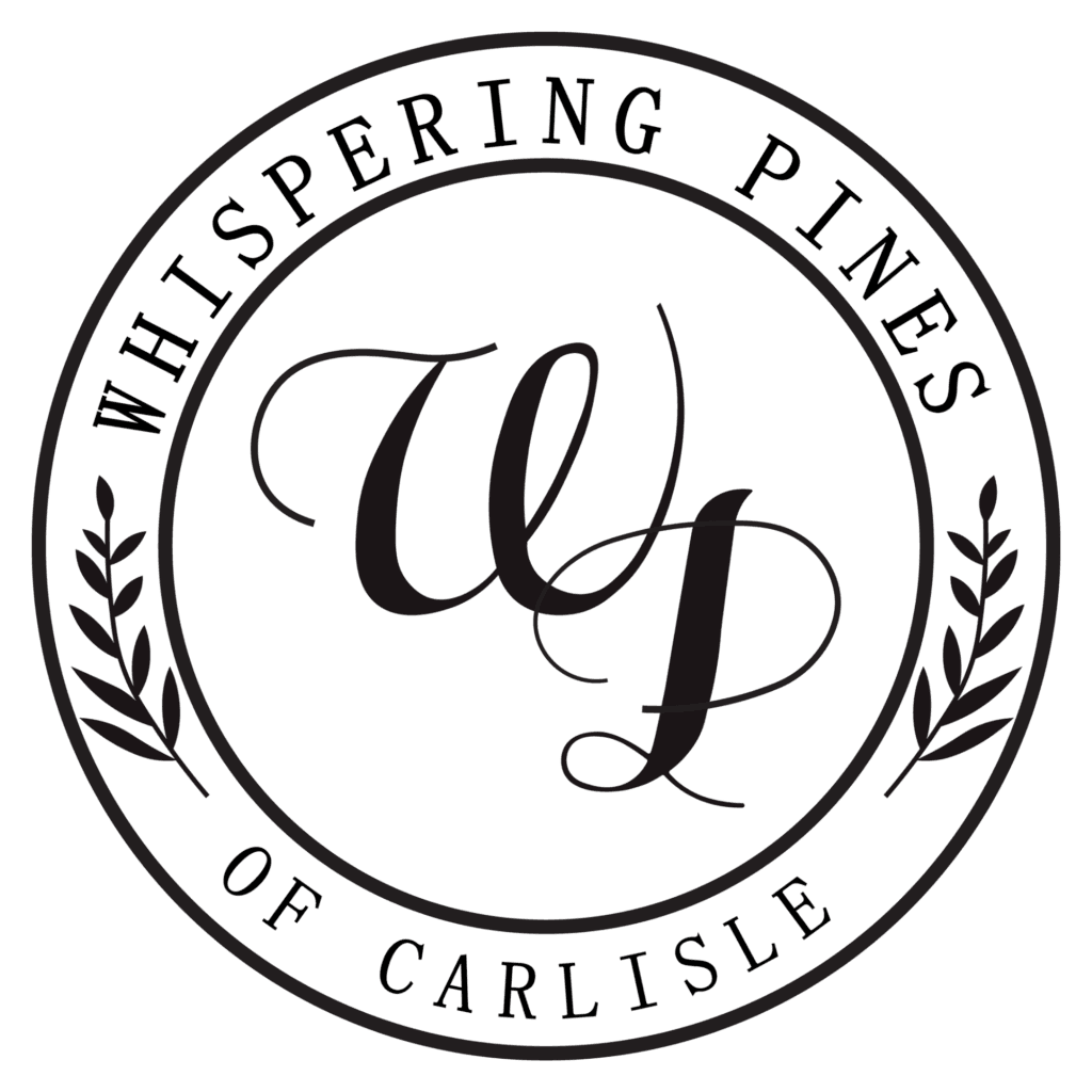 Circular logo with “Whispering Pines of Carlisle” around the edge, stylized “WP” initials in the center, and two laurel branches on each side.
