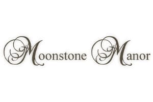The words "Moonstone Manor" are written in a decorative script font with ornate, swirling capital M's on a white background.