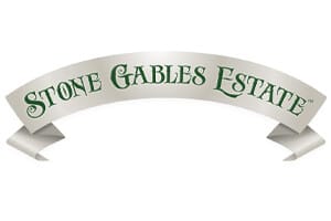 A white ribbon banner with "Stone Gables Estate" written in green, stylized text.