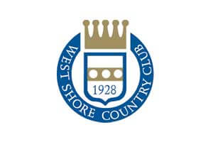 venue-logo-west-shore-cc Logo of West Shore Country Club featuring a gold crowned shield with "1928" and three dots, surrounded by a blue ring with the club's name in white text.
