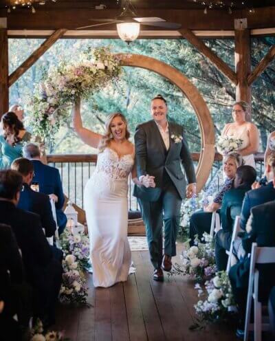 Bride and groom walking down the aisle at an indoor wedding ceremony with Klock Entertainment ceremony sound