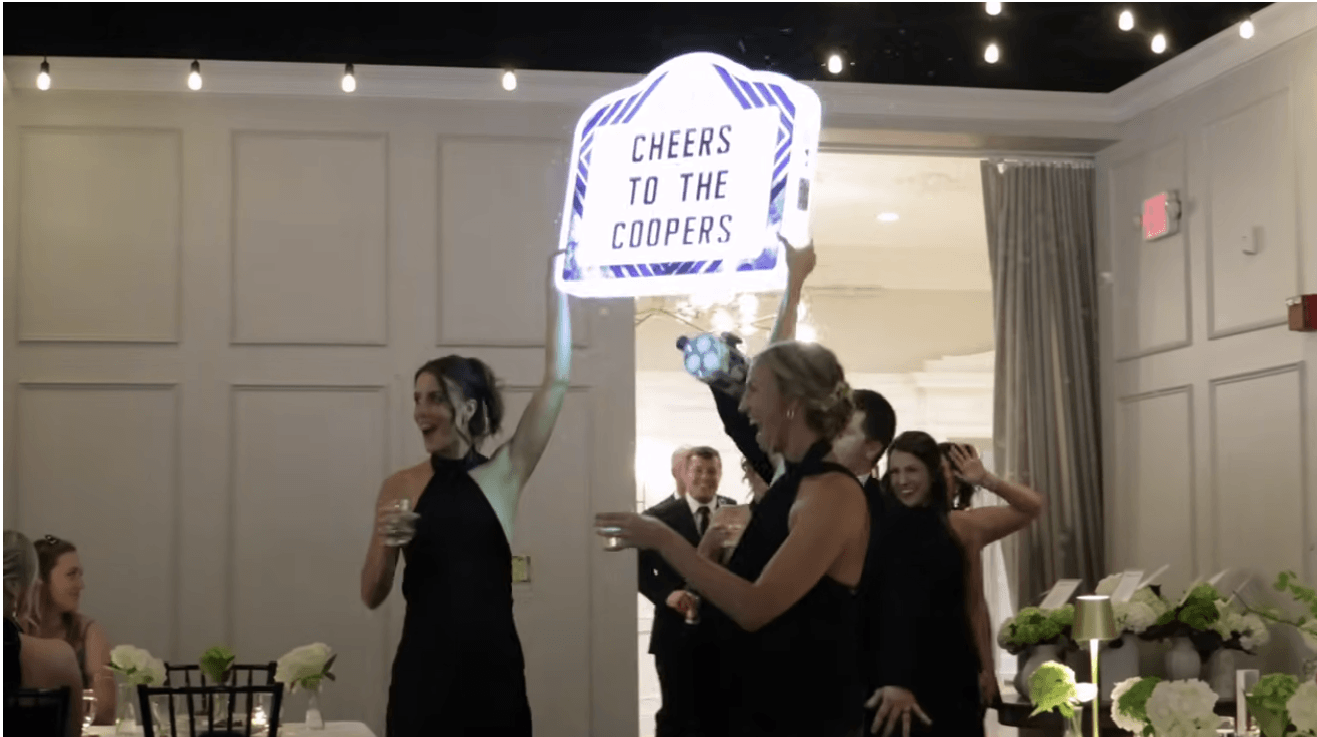 coopers wedding at king mansion bridesmaids holding sign