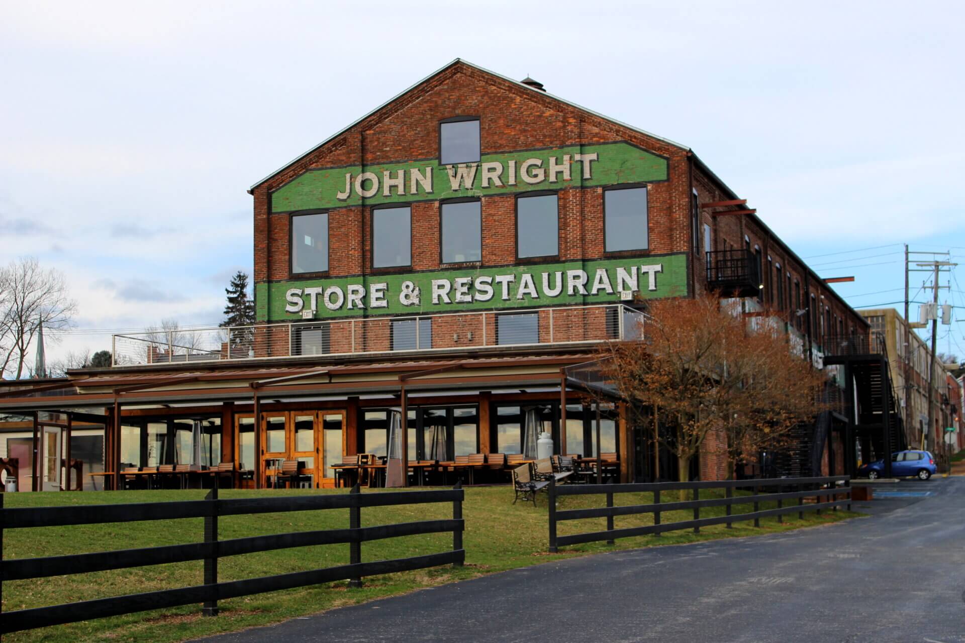 The John Wright Store & Restaurant in a historic brick building with a large outdoor patio.