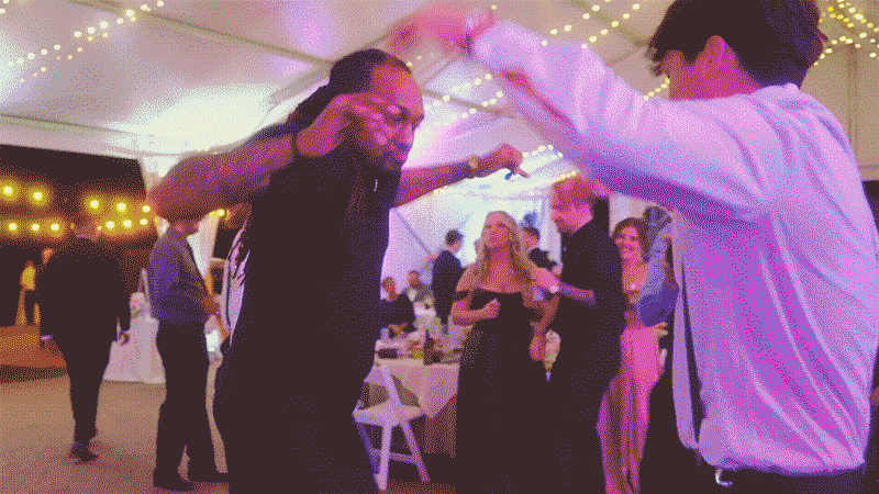 video-for-klock-mobile-32 People dancing at a tented event with string lights.